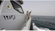 A Saudi border guard watches as he stands in a boat off the coast of the Red Sea on Saudi Arabia's maritime border with Yemen, near Jizan. (Reuters/File photo)