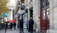 (FILES) This file photo taken on October 03, 2016 shows police officers standing guard at the entrance to a hotel residence at the Rue Tronchet, near Madeleine, central Paris, where US reality television star Kim Kardashian was robbed at gunpoint by assai