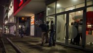 South African policemen deploy in the Braamfontein district of Johannesburg on October 14, 2016 during riots involving university students protesting over planned hikes in tuition fees. / AFP / MUJAHID SAFODIEN