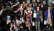 Models display creations by designer Christelle Kocher during the KOCHE AW16 and SS17 mix collection show presented at Amazon Fashion Week in Tokyo. AFP / KAZUHIRO NOGI