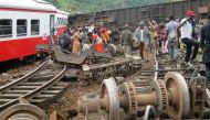 Passenger escapes the site of a train derailment in Eseka on October 21, 2016.  AFP / STRINGER