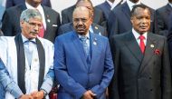 This file photo taken on June 14, 2015 shows Sudanese President Omar al-Bashir (C) standing next to Congo's president Denis Sasso-Nguesso (R) and Prime Minister of the Sahrawi Arab Democratic Republic Abdelkader Taleb Oumar (L) posing during a photo call 