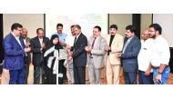 Indian Ambassador P Kumaran hands the first copy of the Chandrika Annual magazine, an Indian publication, to Qatari poet Dr Zakia Ali Malallah. Also seen are Parakkal Abdulla, a member of Kerala's Legislative Assembly, P N Baburajan, K K Usman, C N Unnikr