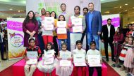 Santosh Pai, (fourth right), COO Landmark Group; Qatar, Rajgopal, (third left), Marketing Manager Landmark Group; and other officials with winners of Baby shop drawing competition ‘Expressions’ at Centerpoint Alasmakh Mall, yesterday. 
Pic Kammutty VP / 