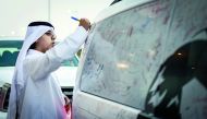 A man signing on a Mercedes-Benz vehicle as part of the national campaign ‘The Journey of Glory’ organised by Nasser Bin Khaled (NBK) Holding. 