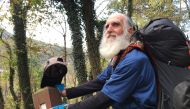 Dale Sanders, 82, stopped to kiss his last trail marker before becoming the oldest person to hike all 2,190 miles of the Appalachian Trail within a year. Washington Post photo by Tara Bahrampour
