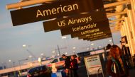 This December 9 2013 photo shows American Airlines and US Airways signs stand next to each others at Denver International Airport Colorado (AFP / Emmanuel Dunand) 