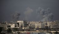 Smoke billows following Syrian government bombardment on the rebel-held besieged town of Harasta, in the Eastern Ghouta region on the outskirts of Damascus on March 10, 2018.  AFP / Ammar SULEIMAN
