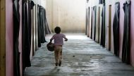 A displaced Syrian child runs at a government-run shelter after they were evacuated by the army from areas in the Eastern Ghouta region recently recaptured from rebels by government forces, on March 12, 2018 in Ad Duwayr on outskirts of Damascus. Syrian g