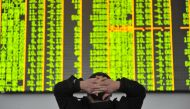 File photo: An investor looks at an electronic screen at a brokerage house in Hangzhou, Zhejiang province, January 26, 2016. REUTERS/China Daily