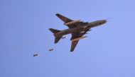 A Sukhoi Su-22 Syrian army plane releases bombs over southern Damascus in the area of Yarmuk Palestinian refugee camp on April 24, 2018.  AFP / Rami al SAYED
