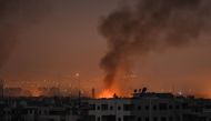 A picture taken late on April 28, 2018 shows smoke plumes rising from explosions in the skyline of a southern district of the Syrian capital Damascus, during regime strikes targeting the Islamic State group in the Palestinian camp of Yarmuk, and neighbour