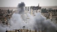 Smoke rises from buildings in a rebel-held neighbourhood of Daraa in southern Syria following reported shelling by the regime on May 22, 2018. / AFP / Mohamad ABAZEED