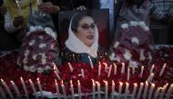 Supporters of Pakistan People's Party hold an image of Pakistan's former prime minister Benazir Bhutto during a candlelight vigil to commemorate her death anniversary in Lahore December 26, 2011. Reuters/Mohsin Raza