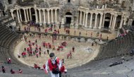 Syrian scouts tour the Roman Theatre at Bosra, a World Heritage Site, south of Sweida, in the Daraa province on November 23, 2018. / AFP / Maher AL MOUNES