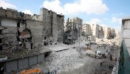 Tractors and trucks remove the rubble from buildings that were heavily damaged during battles between rebel fighters and regime forces, in the former opposition held district of Salaheddin in the northern Syrian city of Aleppo on February 11, 2019. AFP / 