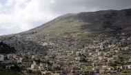 A picture taken from the Syrian town Ain al-Tineh shows the Druze town of Majdal Shams in the Israeli- annexed Golan Heights on March 26, 2019.   AFP / Louai Beshara