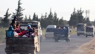 Syrians drive with their belongings along the main Damascus-Aleppo highway near the town of Saraqib in Syria's jihadist-held Idlib province on May 9, 2019 as they flee possible air strikes by the regime and its allies in the area.   AFP / Anas AL-dyab