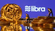 FILE PHOTO: Small toy figures are seen on representations of virtual currency in front of the Libra logo in this illustration picture, June 21, 2019. REUTERS/Dado Ruvic/Illustration