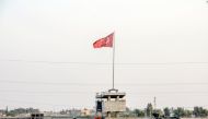 Turkish military truck patrols next to a Turkish flag hoisted at the border with Syria on August 14, 2019, in Akcakale, in Sanliurfa, southeastern Turkey.  AFP 