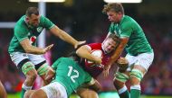 Wales' full-back Hallam Amos is tackled by Ireland's centre Bundee Aki (2nd L) during the international Test rugby union match between Wales and Ireland at Principality Stadium in Cardiff, south Wales on August 31, 2019. AFP / Geoff Caddick