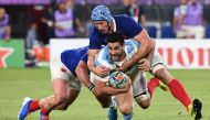 Argentina's centre Jeronimo de la Fuente (C) is tackled by France's wing Yoann Huget (L) and France's flanker Wenceslas Lauret during the Japan 2019 Rugby World Cup Pool C match between France and Argentina at the Tokyo Stadium in Tokyo on September 21, 2