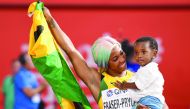 Fraser-Pryce holds her son Zyon after the race.