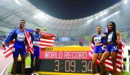 USA's Michael Cherry, USA's Wilbert London, USA's Allyson Felix and USA's Courtney Okolo react after setting a world record in the Mixed 4 x 400m Relay final at the 2019 IAAF World Athletics Championships at the Khalifa International Stadium in Doha on Se