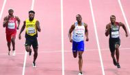 FROM LEFT: Qatar’s Abdelaziz Mohamed, Jamaica’s Rasheed Dwyer, Britain’s Miguel Francis and Canada’s Aaron Brown in action during the men’s 200 metres heats yesterday.