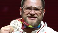 Gold medallist Poland's Pawel Fajdek poses on the podium during the medal ceremony for the Men's Hammer Throw at the 2019 IAAF World Athletics Championships in Doha on October 3, 2019. / AFP / KARIM JAAFAR 