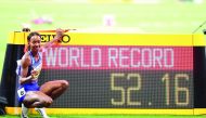 Dalilah Muhammad of the US poses next to the screen reading the new world record in the women’s 400m hurdles final at the 2019 IAAF Athletics World Championships at the Khalifa International stadium in Doha, yesterday. Pictures: Abdul Basit / The Peninsul