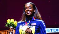 Dalilah Muhammad of the U.S. poses after winning gold and breaking the world record