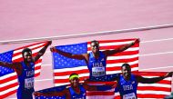 FROM LEFT: USA’s Noah Lyles, Michael Rodgers, Christian Coleman and Justin Gatlin pose with their national flag after winning the men’s 4x100m relay final at the IAAF World Athletics Championships Doha 2019 at the Khalifa International Stadium on Sunday. 