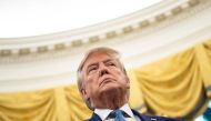 US President Donald Trump listens during a Presidential Medal of Freedom ceremony for Edwin Meese in the Oval Office at the White House in Washington, DC on October 8, 2019. / AFP / Brendan Smialowski