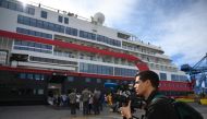 AFP video jounalist Viken Kantarci works before boarding the Hurtigruten hybrid expedition cruise ship, MS Roald Amundsen, in Valparaiso, Chile, on October 27, 2019. AFP / Johan Ordonez