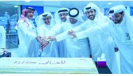 Aspire Zone Foundation staff cutting a cake during Qatar National Day celebrations.