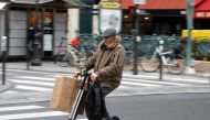 A man rides an electric scooter or 