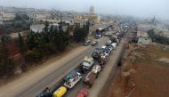 Syrian families from the south of Idlib province driving through the town towards the Syrian-Turkish border as they flee from the assault led by government forces and their allies. December 24, 2019. AFP / Aref TAMMAWI