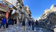 Syrians gather amidst the rubble following regime airstrikes on a market in the town of Binnish in Syria’s northwestern province of Idlib on January 11, 2020. AFP / Omar HAJ KADOUR