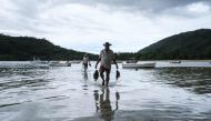 Fishermen carry fish in Mahe island, the largest island contains the capital city of Victoria, Seychelles on November 18, 2019. AFP / Yasuyoshi Chiba  
