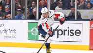 Washington Capitals left wing Alex Ovechkin (8) takes a shot on an empty net against the New York Islanders during the third period at Nassau Veterans Memorial Coliseum. Credit: Dennis Schneidler-USA TODAY Sports 