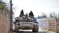 Syrian troops gathering in an area southwest of Saraqeb during their assault on Idlib region. AFP 