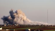 Smoke billows above the rebel-controlled village of Salihiyah near the regime-controlled town of Saraqeb, east of the Idlib province in northwestern Syria, on February 26, 2020, during air stikes by pro-regime forces. / AFP / Omar HAJ KADOUR