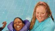 Kathleen Bates, Senior Autism Spectrum Disorder and Special Needs Aquatics Specialist and Coach at Qatar Foundation, with one of the participants in the Ability-Friendly Swimming Program.