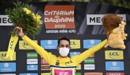 Team Education First rider Colombia's Daniel Martinez celebrates his overall leader's yellow jersey on the podium at the end of the fifth stage of the 72nd edition of the Criterium du Dauphine cycling race, 153 km between Megeve and Megeve on August 16, 2