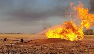 Syrian firefighters putting out a burning pipeline between the areas of Adra and al-Dhamir in the Damascus area. A suspected attack on a pipeline in Syria caused a nationwide blackout overnight, the state news agency quoted authorities as saying.