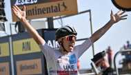  UAE Team Emirates rider Tadej Pogacar of Slovenia, wearing the white jersey for best young rider, crosses the finish line to win the stage Pool via REUTERS/Anne-Christine Poujoulat