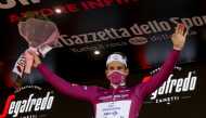 France's Arnaud Demare (Groupama - FDJ), wearing a face mask, celebrates on the podium after winning the seventh stage of the Giro d'Italia 2020 cycling race, a 143-kilometer route between Matera and Brindisi on October 9, 2020. / AFP / Luca Bettini