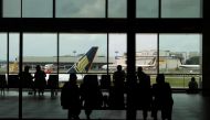 People look at a Singapore Airlines plane, amid the spread of the coronavirus disease (COVID-19), at a viewing gallery of the Changi Airport in Singapore October 12, 2020. REUTERS/Edgar Su