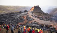 People gather at the volcanic site on the Reykjanes Peninsula following Friday's eruption in Iceland, March 21, 2021. Picture taken March 21, 2021. REUTERS/Cat Gundry-Beck 
